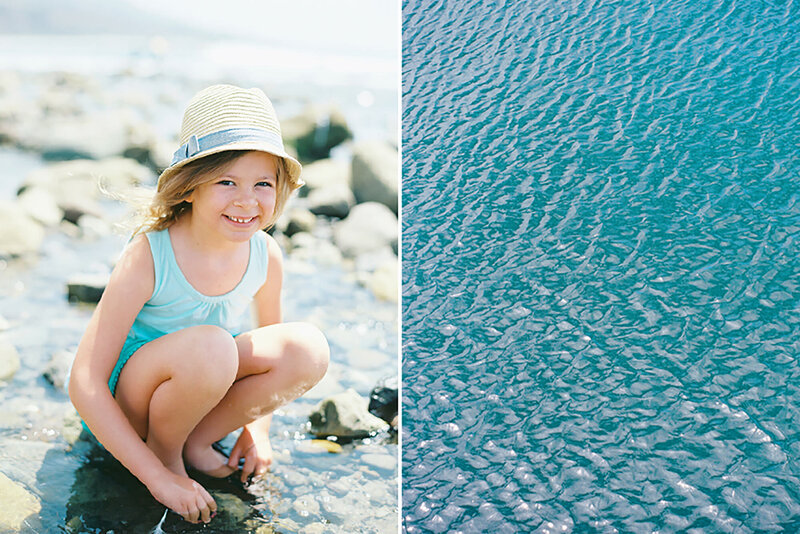 A yound girl in a blue dress in the ocean in Malibu during her natural light portraits