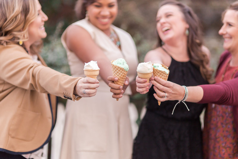 women laughing together with ice cream