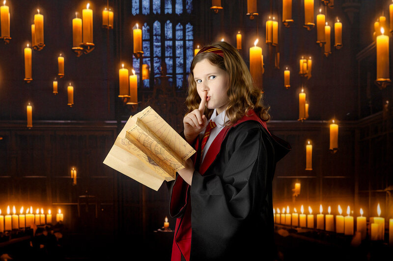 A young girl poses in the Great Hall at the Wizarding School Portrait event in Myrtle Beach, SC