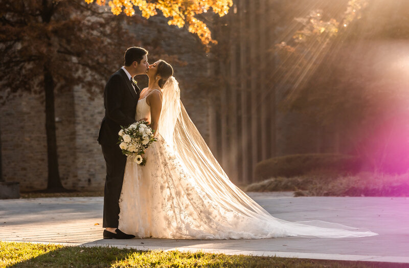 Bride and Groom kissing in sunset lighting at Loyola, Baltimore Wedding Photography