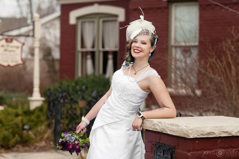 Cute vintage bride with birdcage veil in front of the historic McCreery House wedding venue in downtown Loveland Colorado