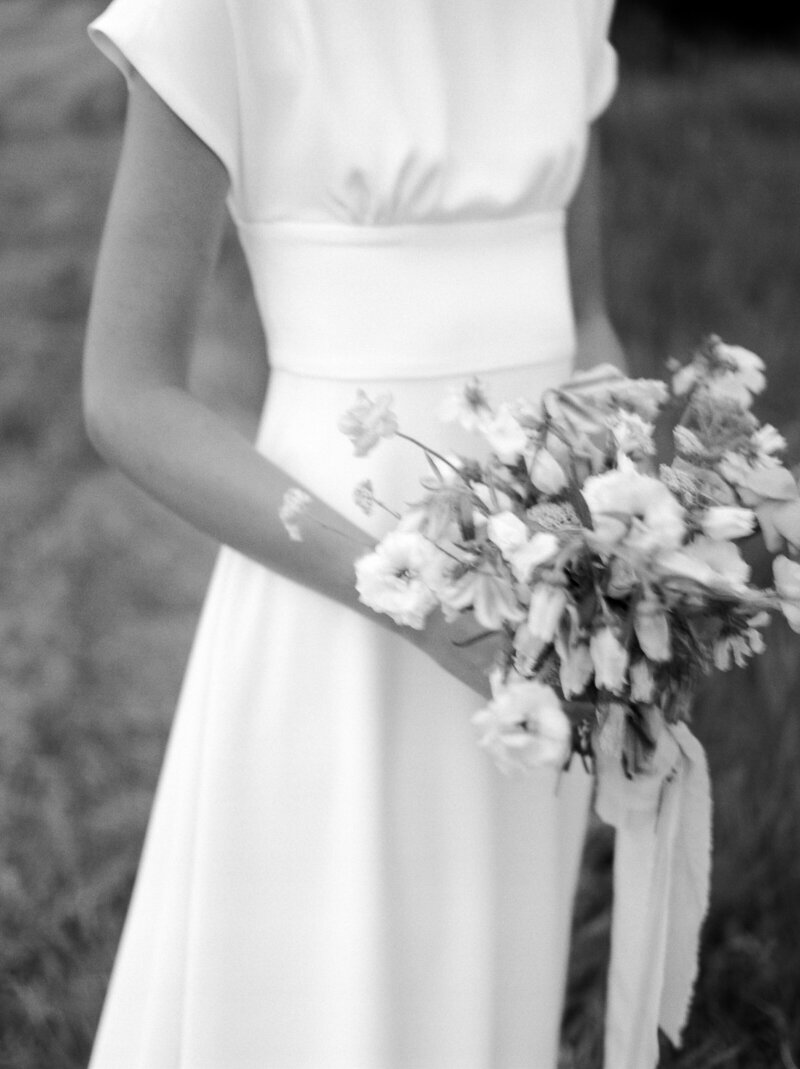 Bride holding floral arrangement