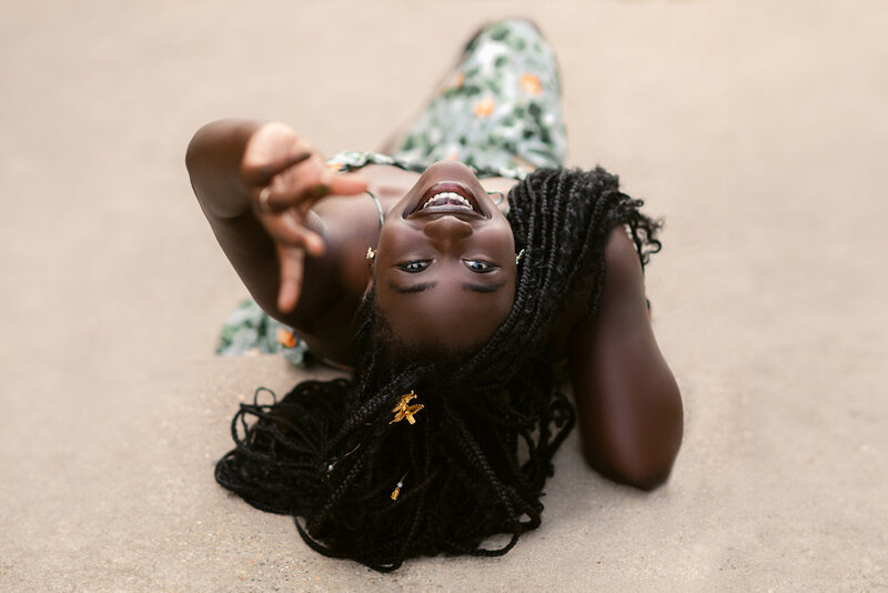 High school senior girl lying down and looking upside down at the camera by Chicago Portrait Photographer Kristen Hazelton