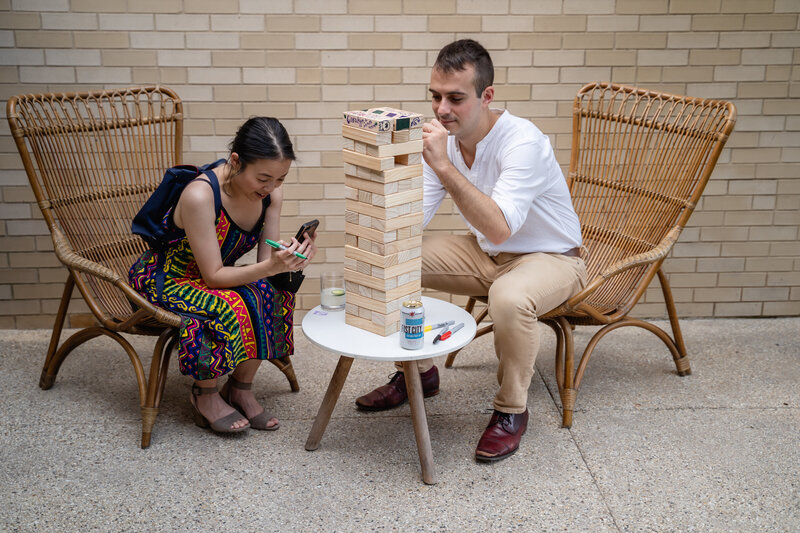 Wedding guests play Jenga during cocktail hour in Chicago