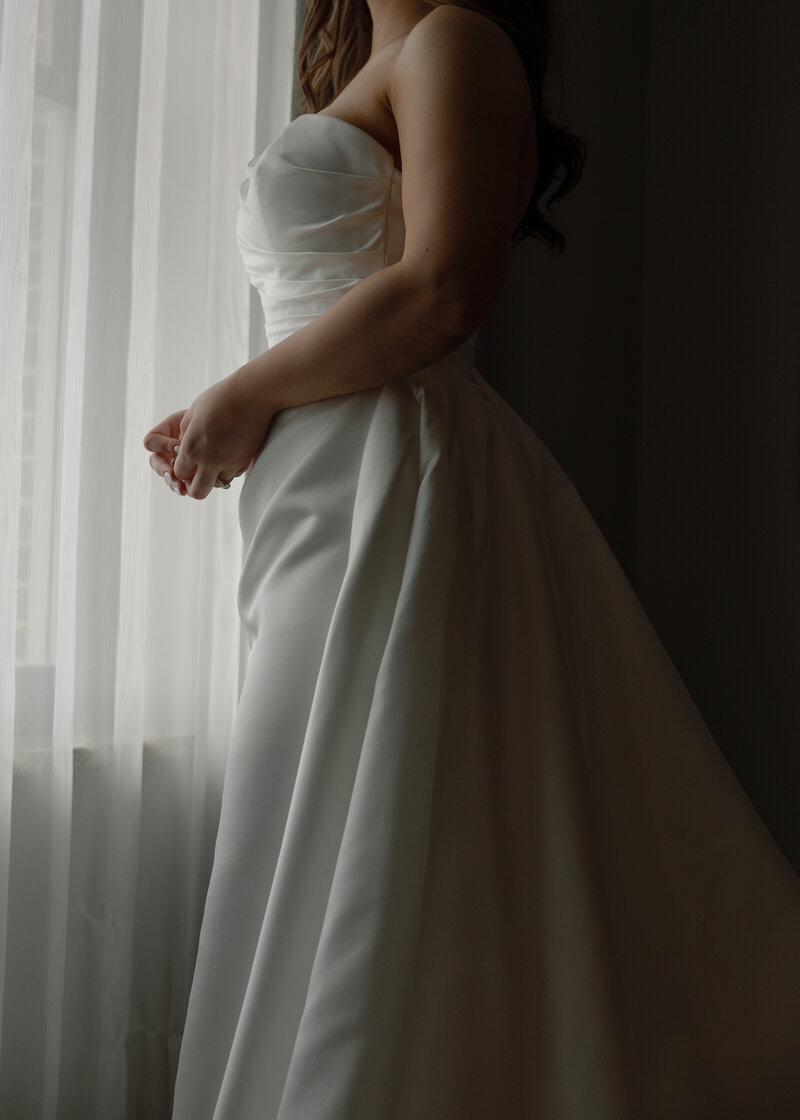 An intimate bridal portrait overlooking the gown.