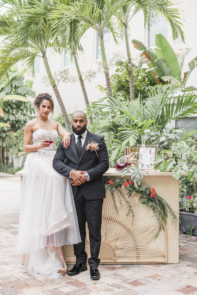 bride and groom portrait under palm trees