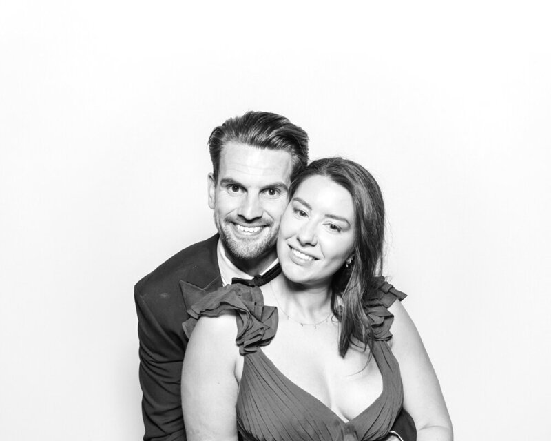 couple posing against a white backdrop for a b&w filter during a kardashian glam photo booth hire