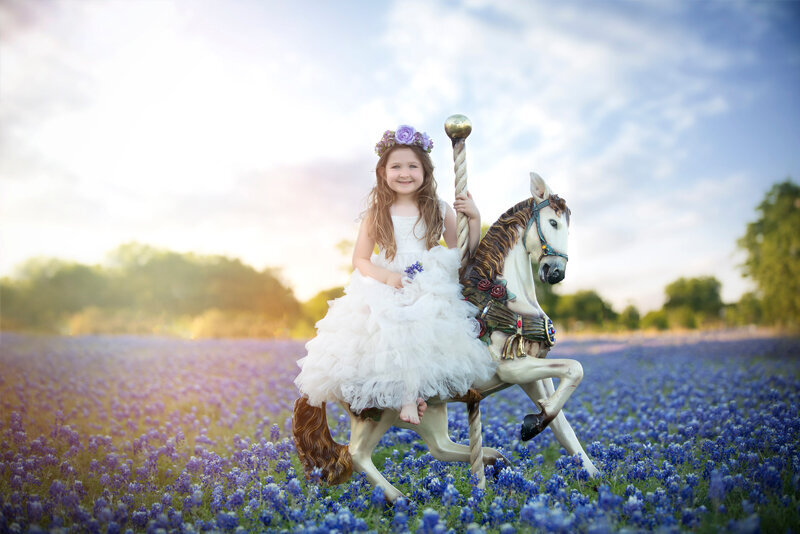 Girl sitting on horse in bluebonnet field.