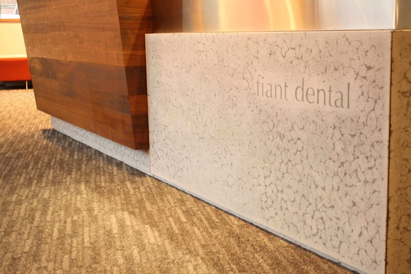 Presed concrete reception desk with integratted logo for Fiant dental