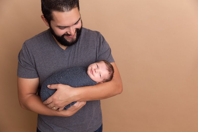 dad holding smiling baby boy