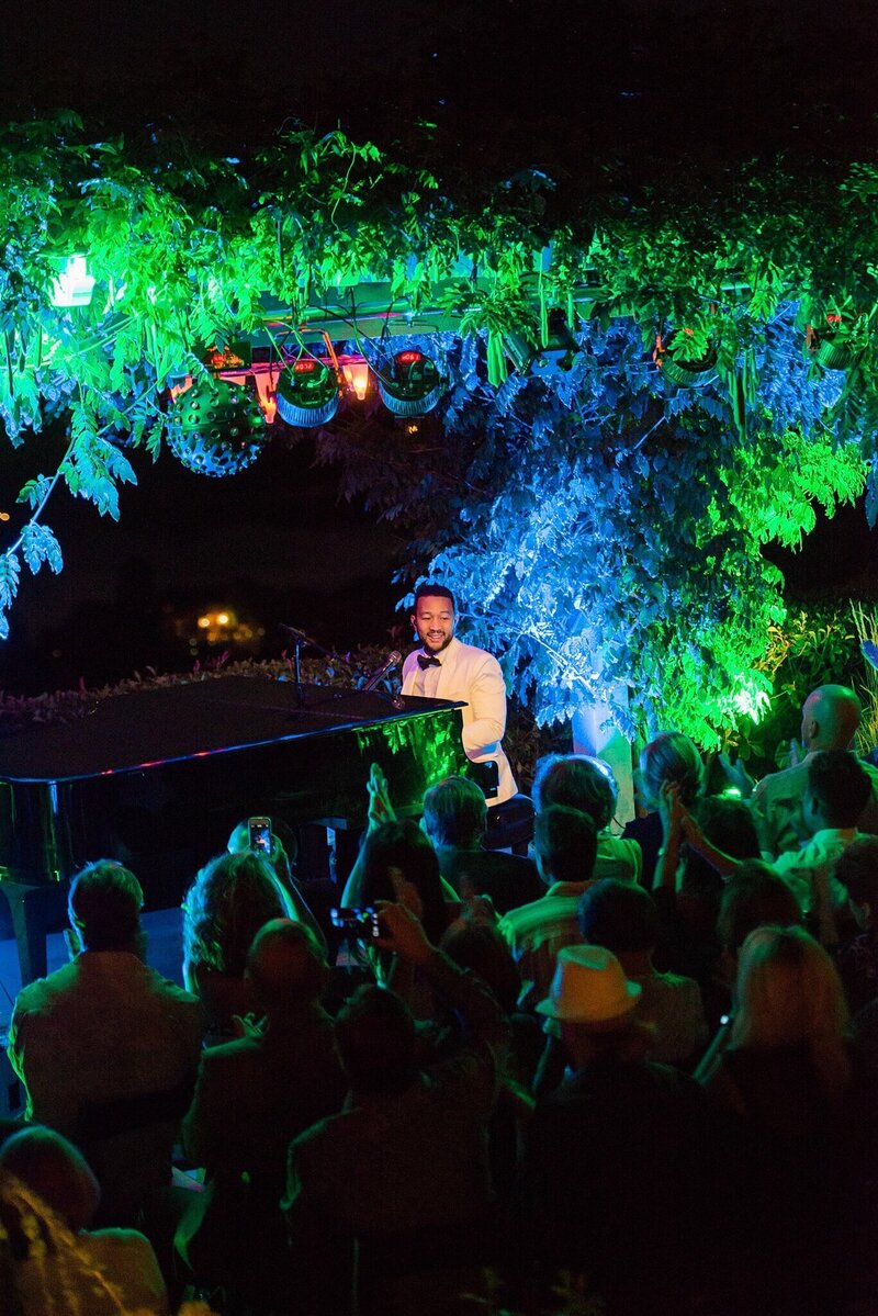 John Legend performs at the piano outdoors with night sky of Reno