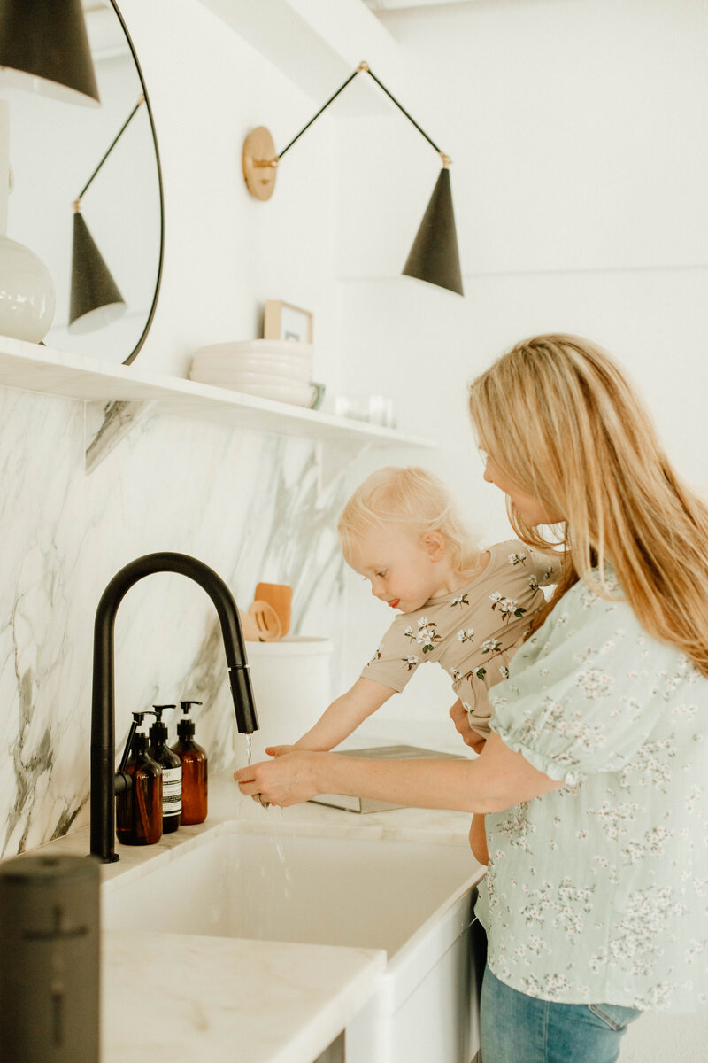 mom and toddler washing hands