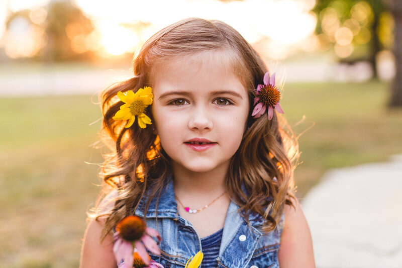 golden hour portrait of girl with flowers in her hair family photographer