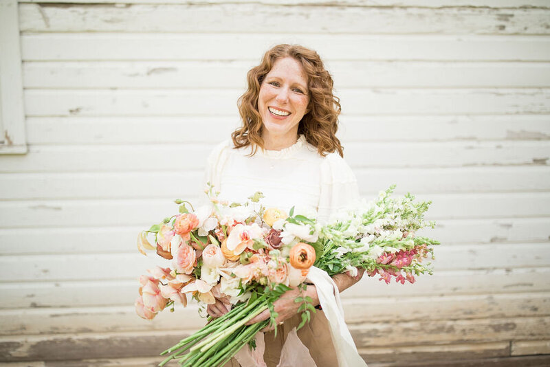 owner with peach and blush bouquet