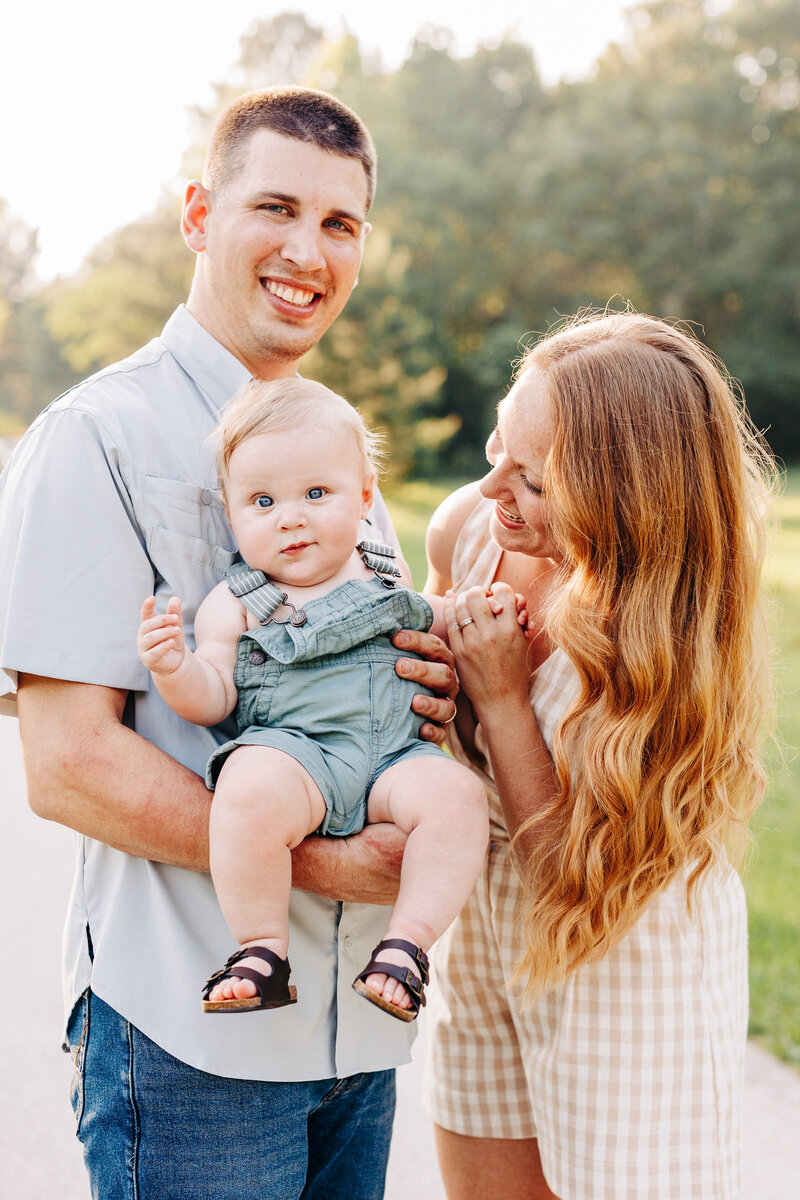 couple holding baby in a photo taken by a houston family photographer