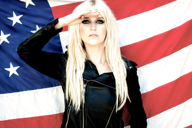American Icon Art Competition Portrait Salute blonde girl in black leather jacket standing against American flag while saluting