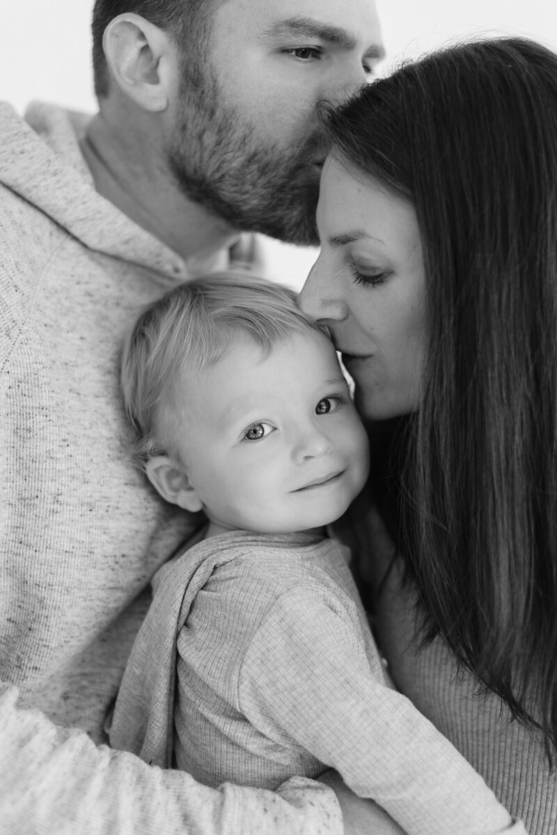 Family of 3 cuddled together in Boise photographers studio.