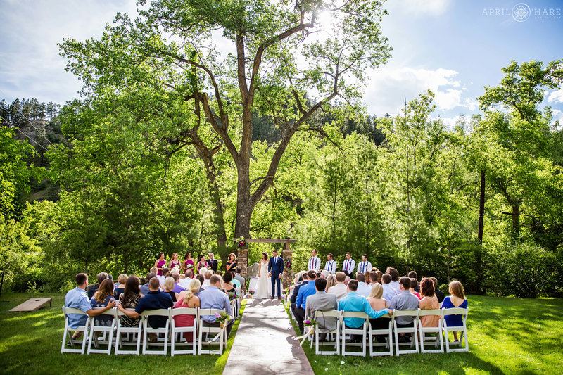 Summer wedding ceremony outdoors on the green lawn at Wedgewood Weddings Boulder Creek
