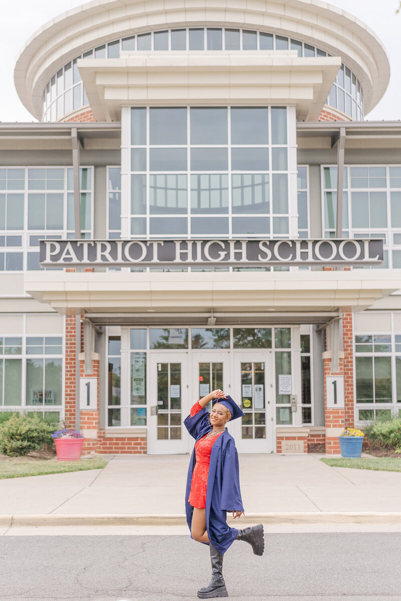 girl wearing graduation cap & gown during senior photos in Nokesville, VA