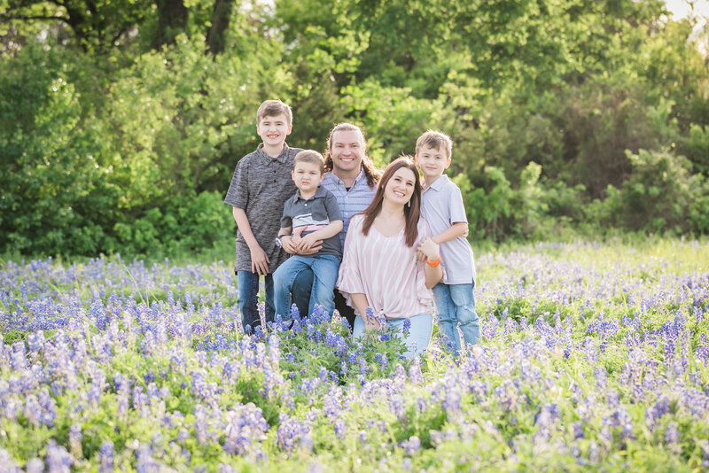 Family of 5 sitting in bluebonnet field, Austin Family Photographer