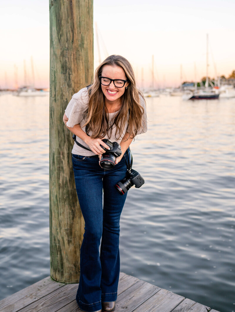 Photographer Kelly Eskelsen laughing on the pier in Annapolis, Maryland.