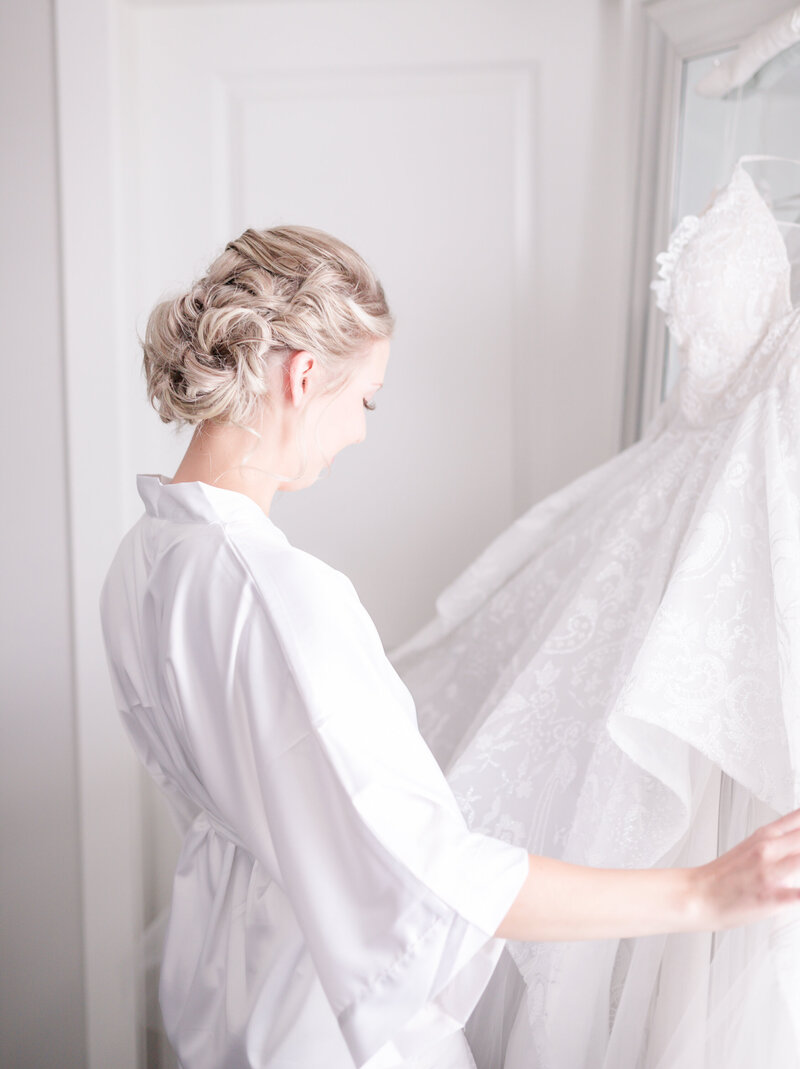 Bride admiring her haley paige wedding dress