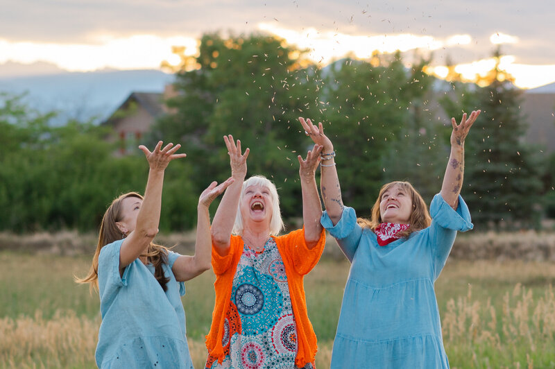 Ladies celebrating throwing seeds up in the air