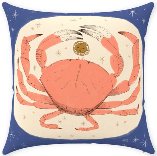 a pillow with an illustration of a crab on the front illustrating the zodiac sign of cancer