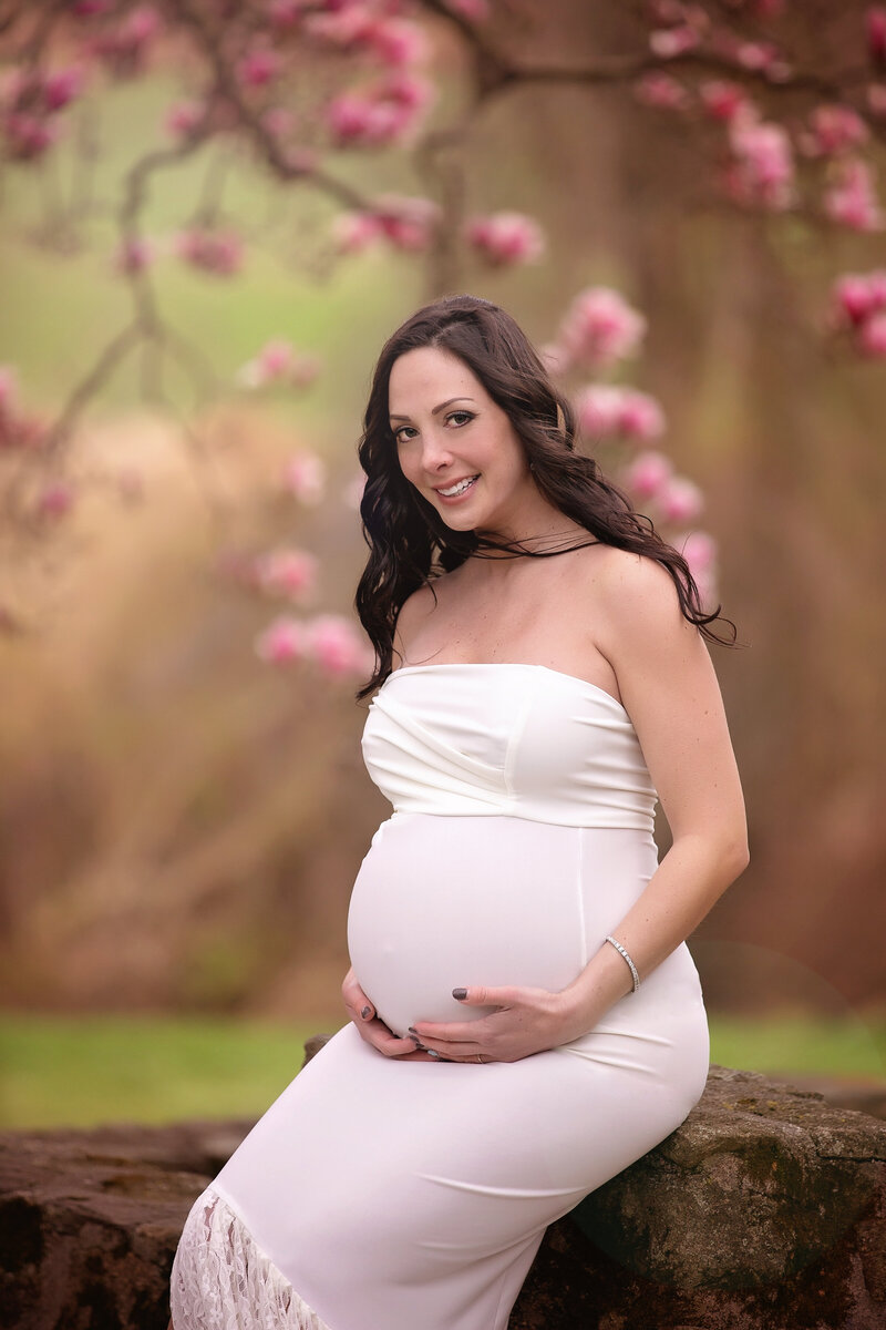 new jersey pregnancy photo with mom to be smiling and wearing a white dress