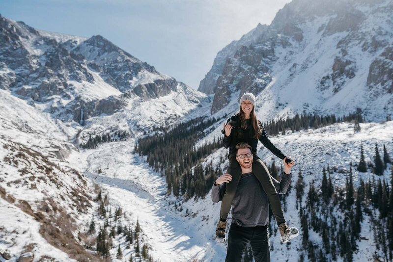 Luke is an adventurous wedding photographer, holding his camera close to him in the mountains.