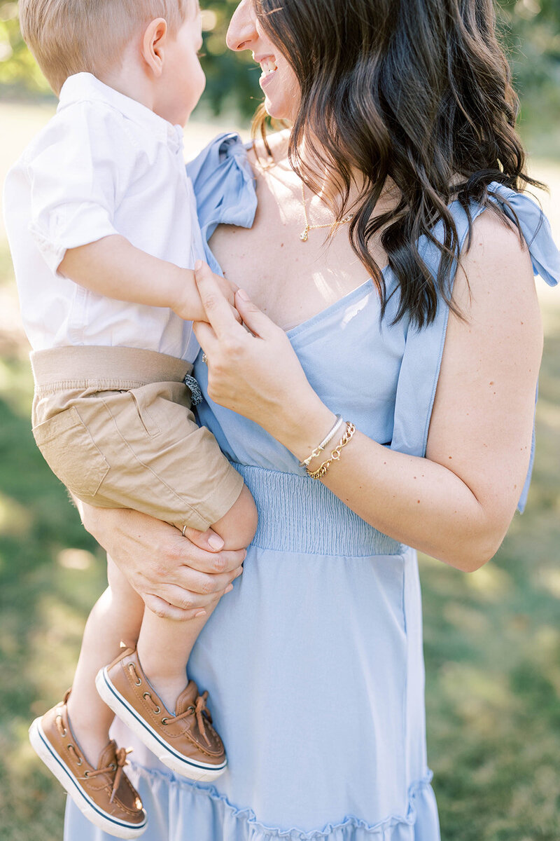Woman holds son outside in a central PA field.