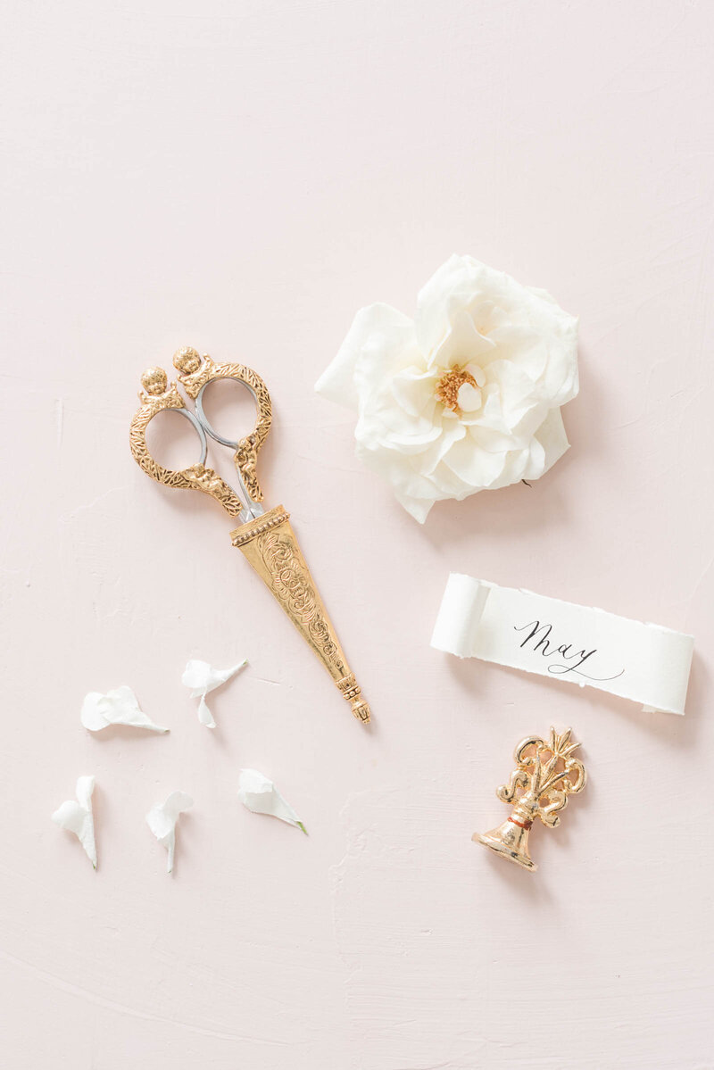A lay flat of luxurious trinkets and soft flowers