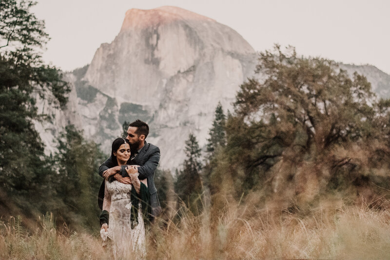 A photo of a bride and groom in Yosemite National Park with Half Dome in the Background.