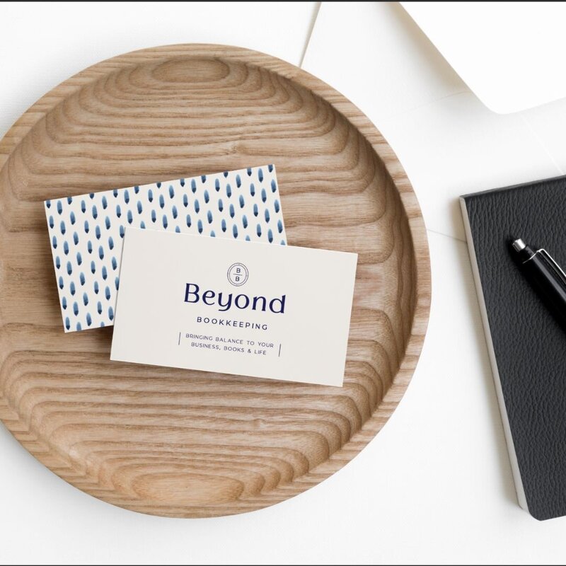 Branded business cards for Beyond Bookkeeping in a wooden bowl