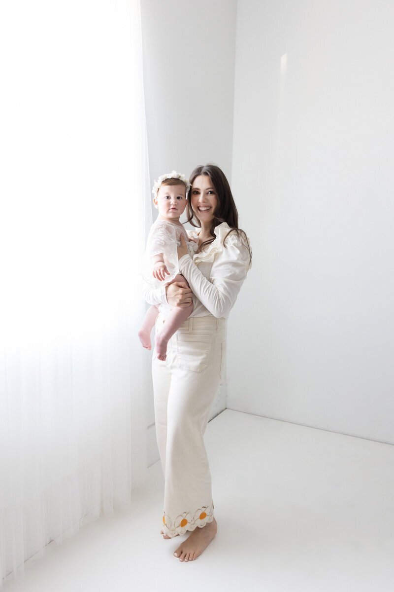 Mom holding baby taken by nj cake smash photographer