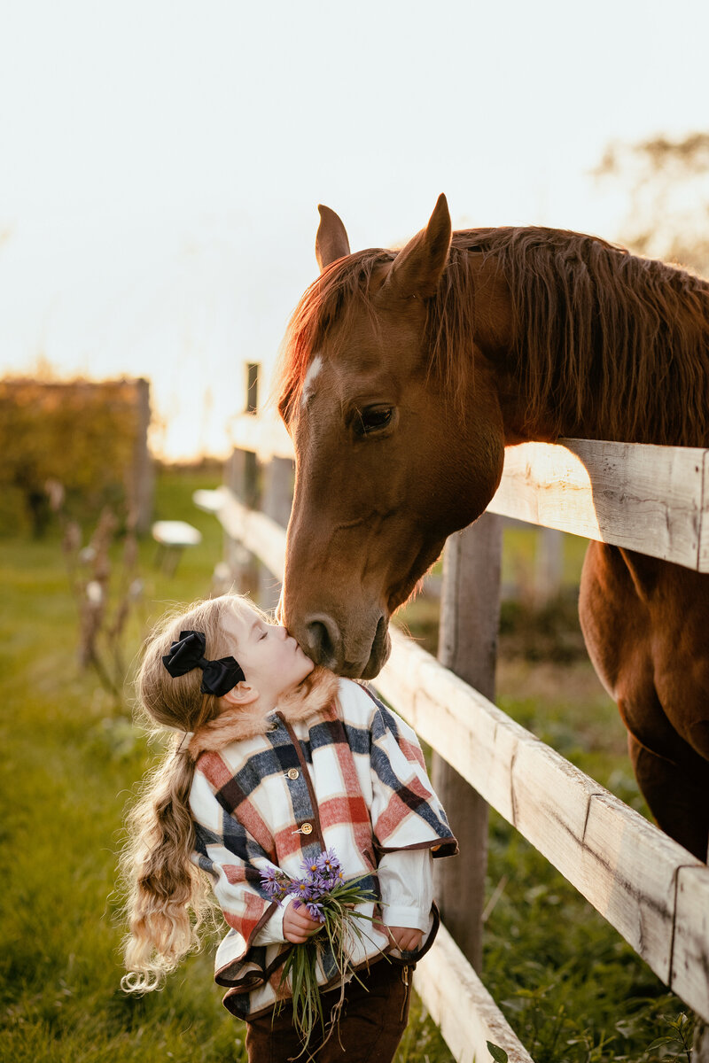 female child kissing horse in st paul