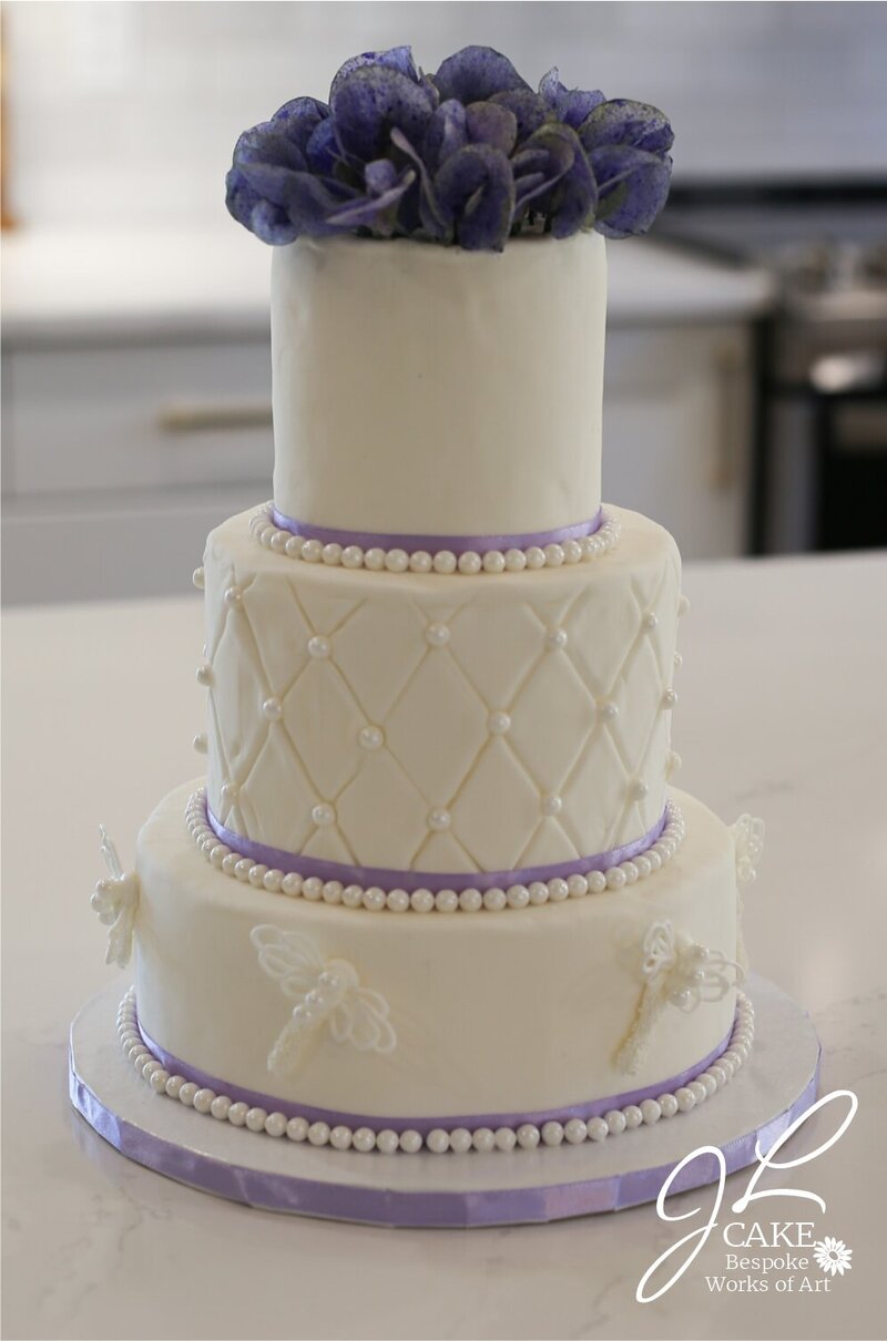 classic design wedding cake, fondant quilting texture and pearls, royal icing dragonflies, and wafer paper sweet peas