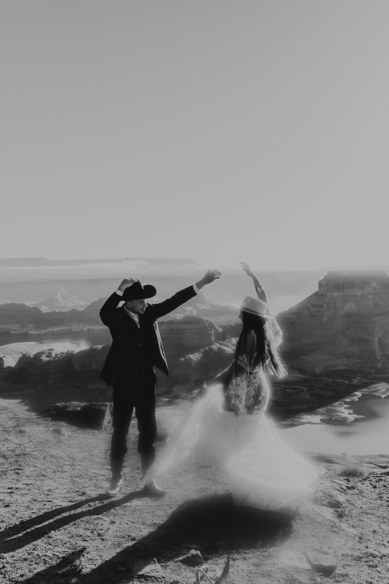 bride and groom dance on cliff