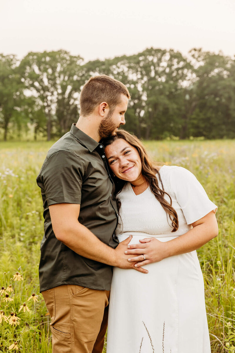 husband holding his wife as they think about their soon to be baby during maternity photography experience