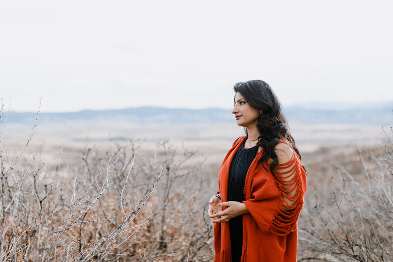 Life coach Radhika standing outside with mountains in background