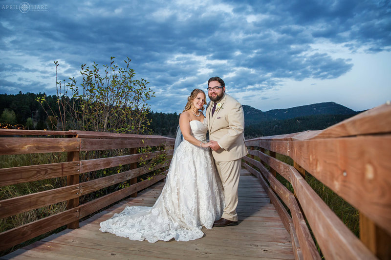 Beautiful blue sky as dusk nears taken on the wood boardwalk at an Evergreen Lake House wedding during fall