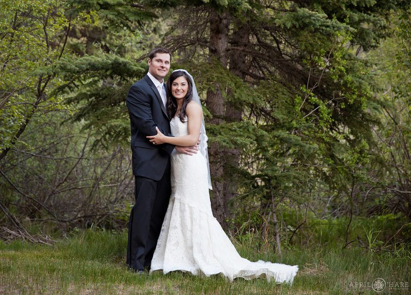 Forest portrait of a wedding couple with pine tree at Mountain View Ranch