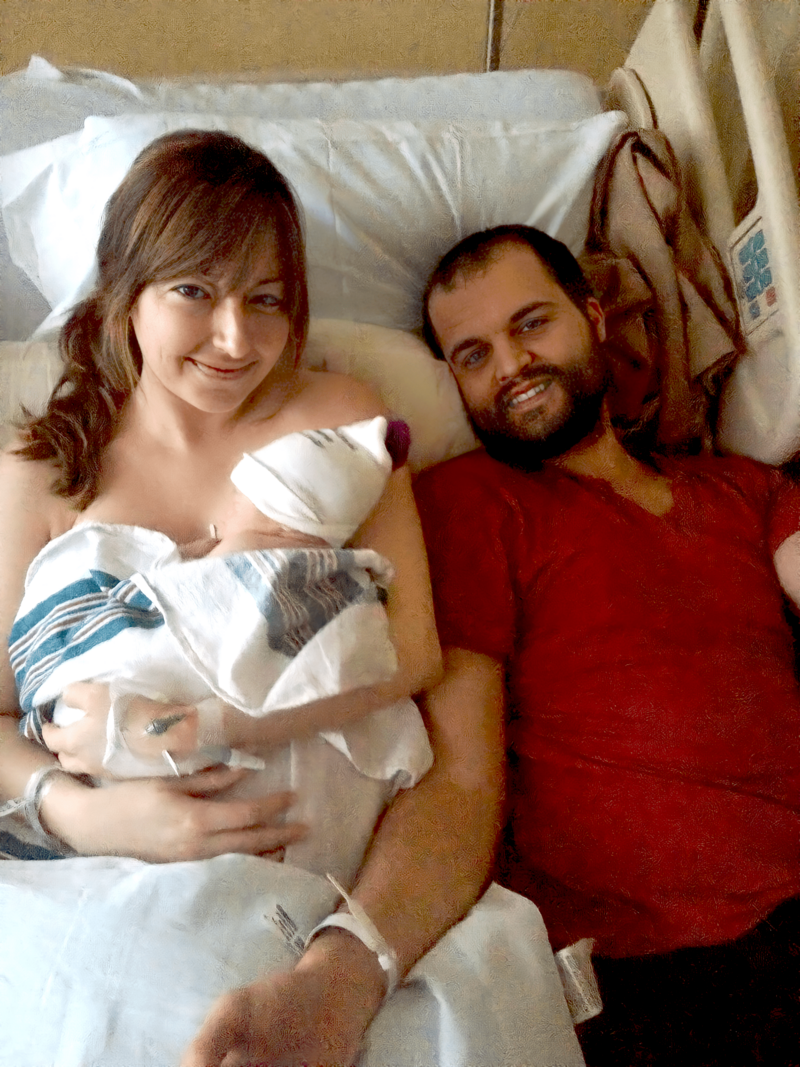 Ali, her husband, and first born child in hospital bed