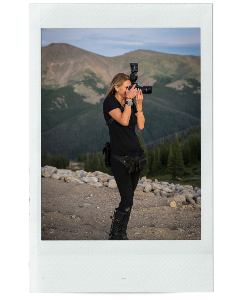 A polaroid style image of Denver wedding photographer, Casey Van Horn, taking a photo with her camera with a Colorado landscape in the background.