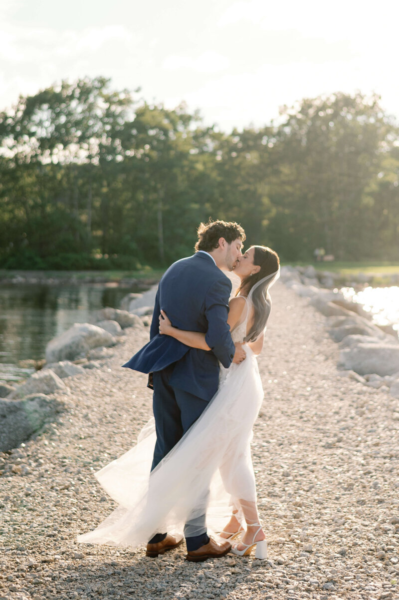 Bride and groom kissing by a lake in Halifax Nova Scotia