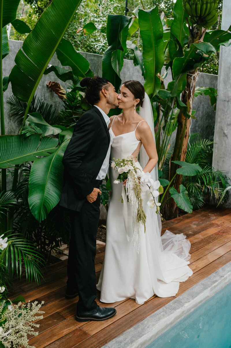 Greta and Jairo kissing after their ceremony at their wedding in Tulum.