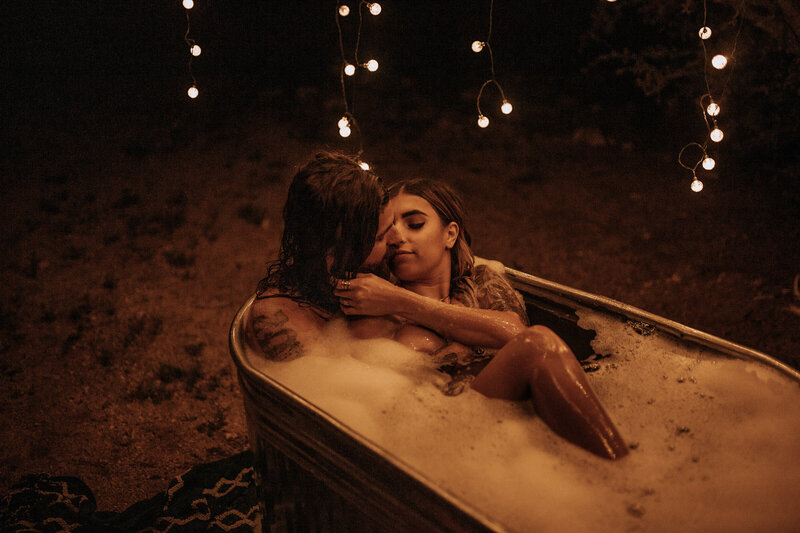 couple kisses under fairy lights