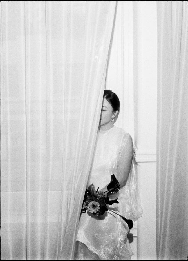 editorial style 35mm film photo of bride behind a curtain at Nine Orchard Hotel NYC