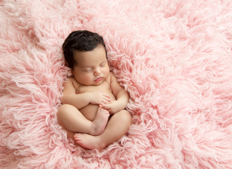 simple baby girl on like pink fur