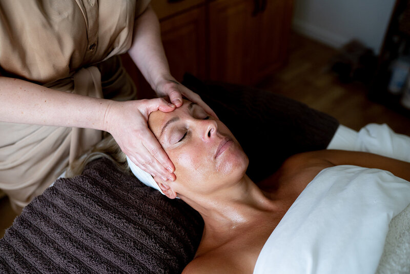 Karli giving client a facial massage